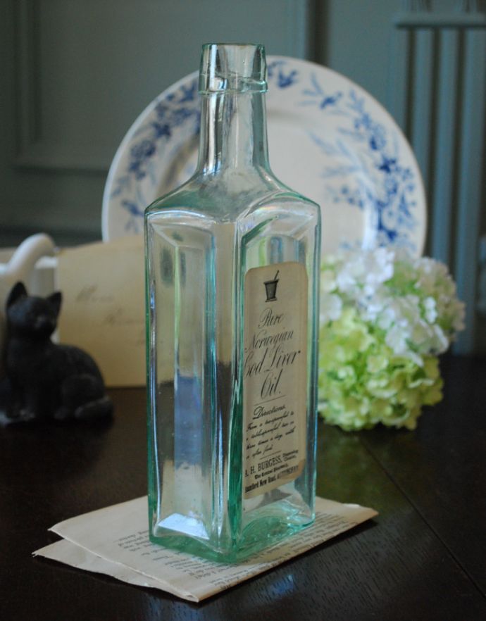 ナチュラルカントリースタイル　アンティーク雑貨　ステッカー付きアンティークガラスボトル(Pure Norwegian Cod Liver Oil)。長年使われてきたボトルはとっても味わい深い一品です。(m-1493-z)