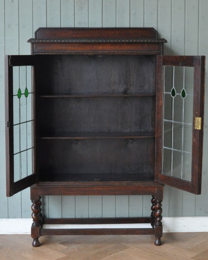 アンティークのキャビネット　アンティーク家具　美しいステンドグラスの扉、英国輸入のアンティーク家具（ブックケース）。食器や写真立て、本やDVDなどなど、たくさん飾ればディスプレイの幅が広がります！ガラスが大きいので、中に飾ったものがいい感じに見えてオシャレになります。(q-952-f)