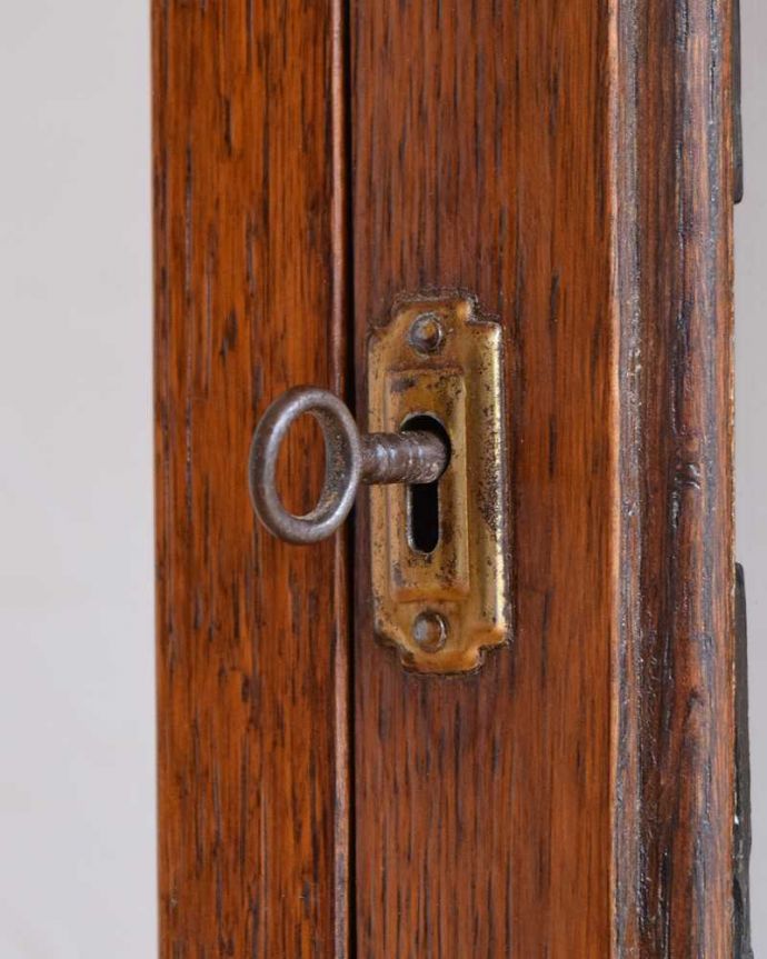 アンティークのキャビネット アンティーク家具 シンプルな美しさが大人っぽい、ウォルナット材のアンティークガラスキャビネット。開ける度にワクワクアンティークらしくカギが取っ手の代わり。(k-2063-f)