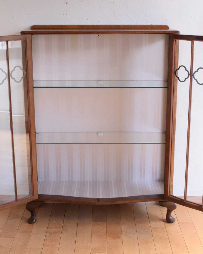 アンティークのキャビネット　アンティーク家具　イギリス輸入のアンティーク家具、木の装飾が可愛いガラスキャビネット（ショーケース）。扉を開けて中を見てみましょう職人がキレイに修復して、背板も新しい生地に張替えました。(k-2145-f)