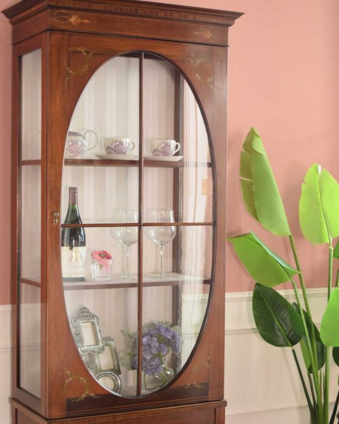 アンティークのキャビネット アンティーク家具 小さなバラが描かれた美しい英国のアンティーク キャビネット。扉に描かれた模様の美しさアンティークのガラスを通して中に入っているものを見ると、なんだかちょっと高級に見えるんです。(k-2373-f)