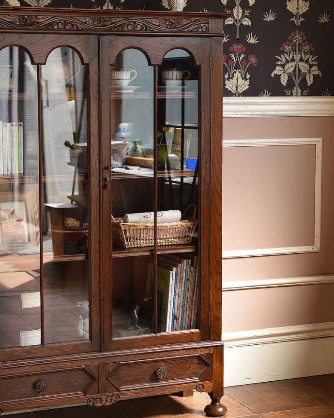 アンティークのキャビネット　アンティーク家具　木のアーチが美しいガラス扉のアンティーク家具、イギリス輸入のブックケース。ガラス越しに中をのぞいてみると･･･アンティークのガラスを通して見ると、どんなものでも中に入れたものが、ちょっと高級に見えちゃうんです。(q-1202-f)