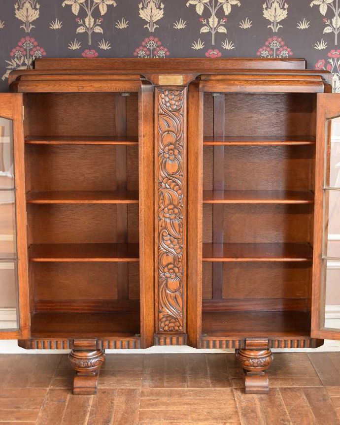 アンティークのキャビネット アンティーク家具 英国のアンティーク家具、お花の彫刻が華やかなブックケース。扉を開けると、中はこんな感じです木の棚板は、もともとブックケースとして使われていた証。(q-1353-f)