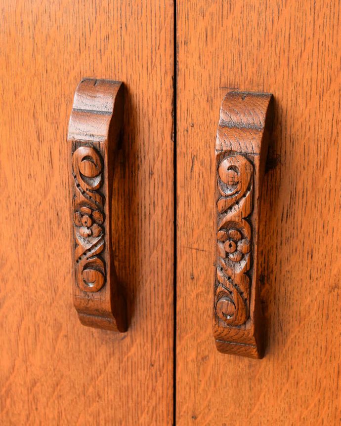 アンティークのキャビネット　アンティーク家具　イギリスアンティークの収納家具、お花の彫刻入りのブックケース（キャビネット）。英国らしいドッシリ感アンティーク家具は取っ手もカッコイイんです。(q-2044-f)