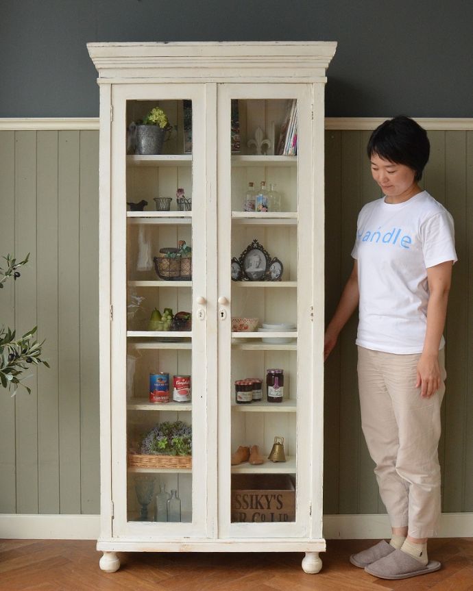 アンティークのキャビネット アンティーク家具 フランスのインテリアを楽しむアンティーク家具、ペイント仕上げのガラスキャビネット 。フランスらしい優雅さと風格が自慢ドッシリと重厚感ある佇まいとフランスらしい優雅な彫の両方を贅沢にも兼ね備えたガラスのキャビネット。(x-1229-f)